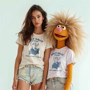 A woman wearing a white t-shirt with a graphic of a turtle and the text 