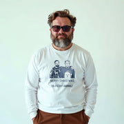 A man wearing a white long-sleeved shirt with a graphic design featuring two men and text.