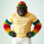A person wearing a yellow t-shirt with a message and colorful fur on their arms and legs.