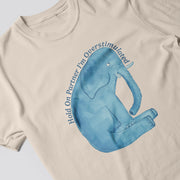 A beige t-shirt with a blue elephant graphic and text that reads 