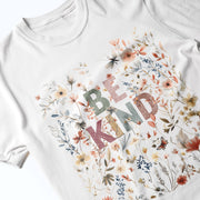 A white t-shirt with a colorful floral design and the text 