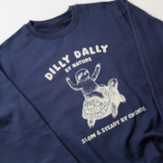 A navy blue sweatshirt with a white graphic design depicting a sloth riding a turtle. The text on the sweatshirt reads 