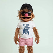 A cartoon character with long brown hair, wearing a black beanie, sunglasses, and a white t-shirt with a graphic design.