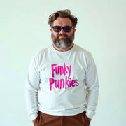 A man with a beard wearing a white long-sleeved shirt with pink text and sunglasses stands against a plain white background.