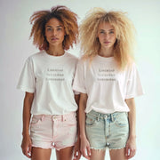 Two young women with curly hair wearing white t-shirts with the text 