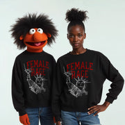 Two people wearing black sweatshirts with the text 