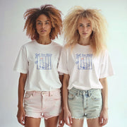 Two young women with curly hair wearing white t-shirts with a graphic design stand side by side against a white background.