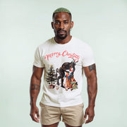 A man wearing a white t-shirt with a Christmas-themed graphic and text, standing against a light background.