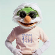 A person wearing a green and white costume with sunglasses and a pink t-shirt with a graphic design.