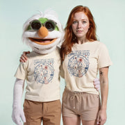 A person wearing a white t-shirt with a graphic design and a character wearing a white t-shirt with a similar graphic design stand next to each other.