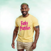 A smiling man wearing a yellow t-shirt with the text 