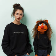 A woman in a black sweater with the text 