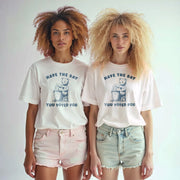 Two young women wearing white t-shirts with the text 
