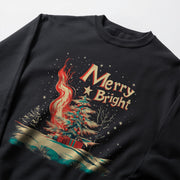 A black sweatshirt with a graphic design depicting a Christmas tree with a fire burning at its base, surrounded by snow and stars.