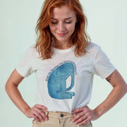 A woman with red hair wearing a white t-shirt with a blue elephant graphic and text printed on it.