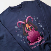 A navy blue sweatshirt with a graphic design featuring a man wearing a red tie and a pink hat, with horns and a purple bag, surrounded by snowflakes.