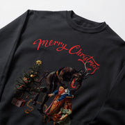 a black sweater with a graphic design depicting a man and a woman sitting on a bench, with a large, ominous creature looming over them. The creature appears to be a combination of a devil and a witch, with the devil having horns and the witch having a long tail. The text 