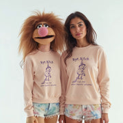 Two women wearing matching pink sweatshirts with a cartoon character on them, posing together.