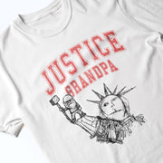 A white t-shirt with a graphic design featuring a drawing of the Statue of Liberty and the text 