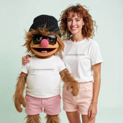 A woman and a large, furry character wearing sunglasses and a beanie, both wearing white t-shirts with the text 