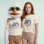 A person wearing a white t-shirt with a graphic of a man and a dog, and another person wearing a beige t-shirt with a graphic of a man and a dog, posing together.