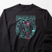 A black sweatshirt with a graphic design featuring a clock and various celestial elements, along with text that reads 