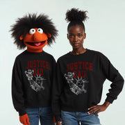 Two people wearing black sweatshirts with the text 
