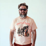 A man wearing a t-shirt with a Christmas-themed graphic and text, smiling at the camera.