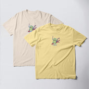 two t-shirts with a frog design, one in a light beige color and the other in a bright yellow color.