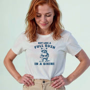A woman wearing a white t-shirt with a graphic design and text printed on it.