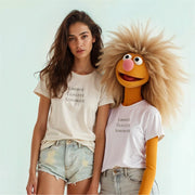 A woman with long brown hair wearing a white t-shirt with the text 
