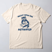 A white t-shirt with a graphic design featuring a raccoon holding a baby and the text 