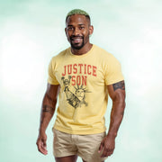 A smiling man wearing a yellow t-shirt with the text 