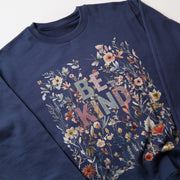 A navy blue sweatshirt with a floral print design and the text 