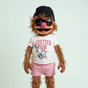 A cartoon character with long hair, wearing a black beanie, sunglasses, and a white t-shirt with the word 
