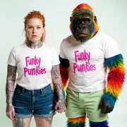 A woman with red hair wearing a white t-shirt with pink text and a man dressed as a gorilla wearing a white t-shirt with pink text.
