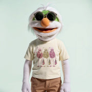 A person wearing a white t-shirt with a graphic design of three cartoon-like figures and sunglasses.