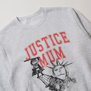 A grey sweatshirt with a graphic design featuring a person and a statue of the Statue of Liberty.
