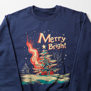 A navy blue sweatshirt with a Christmas-themed design on the front. The design includes a tree, a house, and a campfire, along with the text 