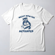 A white t-shirt with a graphic design featuring a raccoon holding a baby and the text 