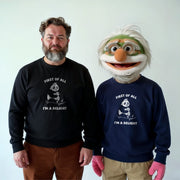 Two men wearing matching black and blue sweatshirts with the text 