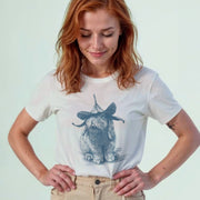 A woman with red hair wearing a white t-shirt with a graphic of a rabbit wearing a hat.