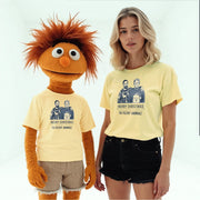A person wearing a yellow t-shirt with a graphic of two men and the text 
