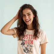 A smiling woman with long brown hair wearing a white t-shirt with a graphic design.