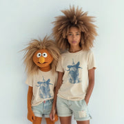 Two people wearing matching t-shirts with a cartoon character design stand together against a white background.