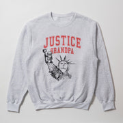 A gray sweatshirt with a graphic design featuring a drawing of the Statue of Liberty and the text 