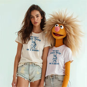 A woman wearing a white t-shirt with a graphic and text, and a large, furry character wearing a white t-shirt with a graphic and text.