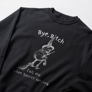 A black sweatshirt with a white graphic design depicting a frog wearing a witch's hat and holding a broom, along with the text 