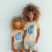Two people wearing matching t-shirts with a cartoon character design stand together against a white background.