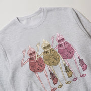 A gray sweatshirt with a colorful illustration of three cartoon-like characters, each holding a different object, such as a handbag and a cup.